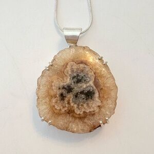 1 1/2 inch, Solar Quartz pendant on a silver chain.